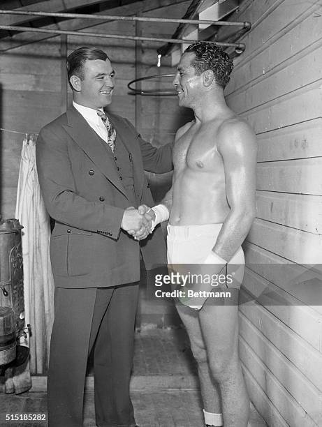 Speculator, NY- Jimmy Braddock , the new heavyweight champion of the world, shakes hands with Max Baer, the former champion, to wish him luck for his...