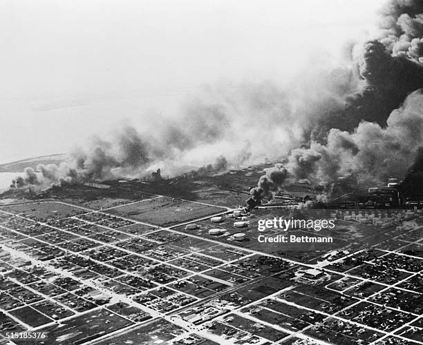 Texas City, TX- Aerial view of burning waterfront in Texas City, showing fires spreading among oil storage tanks. All but a few storage tanks in the...