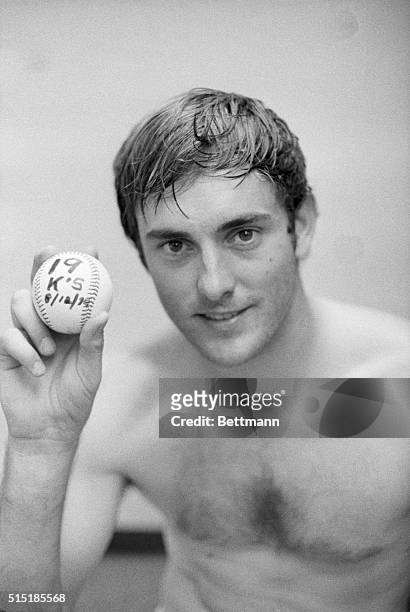 Anaheim, CA- California Angels' pitcher Nolan Ryan holds ball in dressing room with "19," the total strikeouts he had in the game against the Boston...