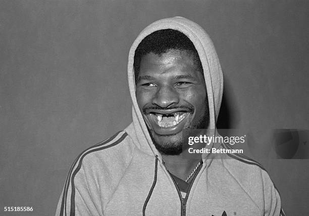 Detroit, Michigan-ORIGINAL CAPTION READS: Former heavyweight champ Leon Spinks shows off his famous smile after he arrived in Detroit to continue...