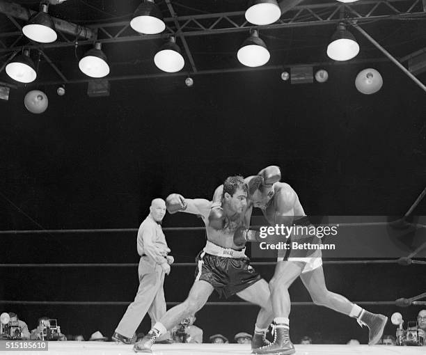 Philadelphia, PA- This ninth round action is typical of the bruising battle waged by world heavyweight champion Jersey Joe Walcott and undefeated...