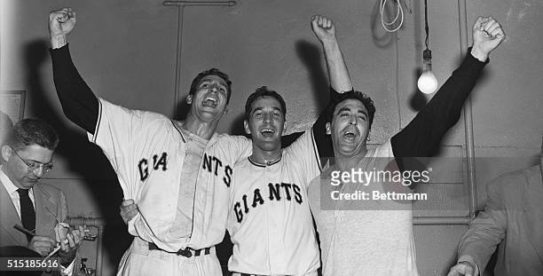 Bobby Thomson, Larry Jansen, and Sal Maglie celebrate in their locker room following the Giants' Game 3 playoff victory over the Brooklyn Dodgers,...