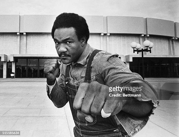 Uniondale, New York: Heavyweight contender George Foreman strikes a fighting pose in front of Nassau Coliseum here where he meets Joe Frazier in a...