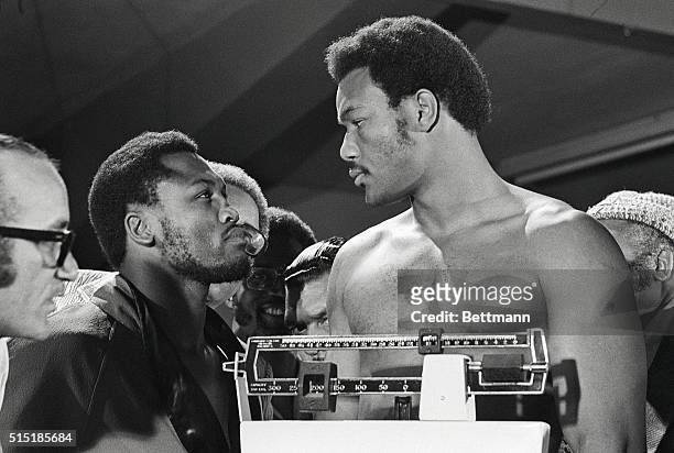 Kingston, Jamaica: World heavyweight champion Joe Frazier and challenger George Foreman go at a staring match during their weigh-in for the title...