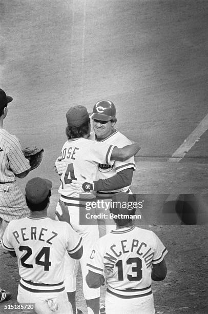 Cincinnati, Ohio- Pete Rose is hugged by his son, Pete, after getting his 4,192 hit to break Ty Cobb's record. Waiting to congratulate Rose are...