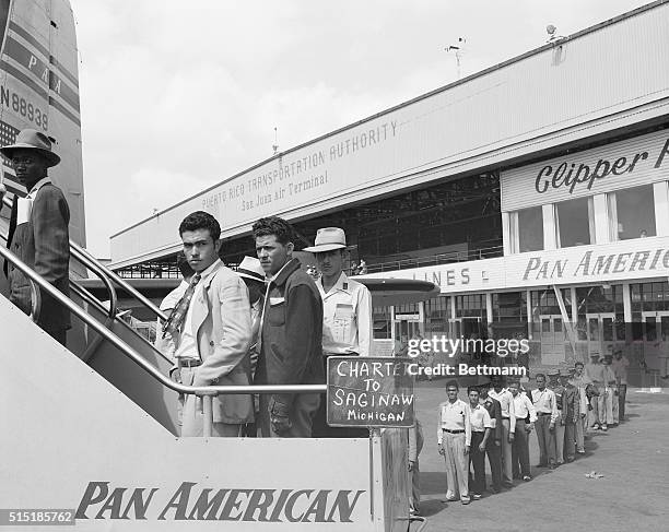 San Juan, Puerto Rico- At San Juan's Isla Grande Airport, migratory farm workers are shown boarding one of the special planes which took them to the...