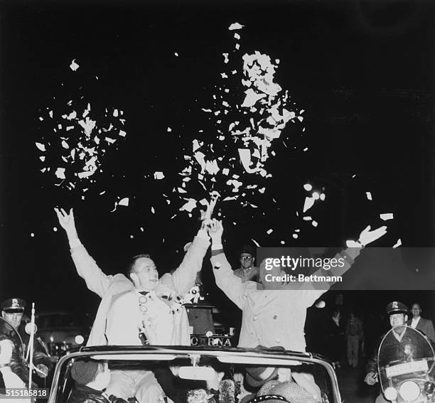 Milwaukee, WI- Braves' hurlers Lew Burdette and Warren Spahn toss confetti during a parade welcoming home the new world champs of baseball. Between...