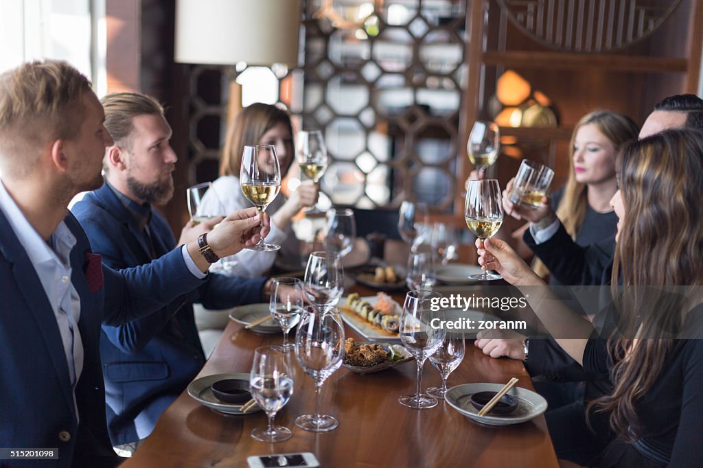 Friends toasting wine in restaurant