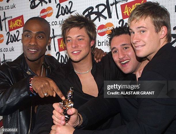 British boy band 'Blue' Simon Webb, Duncan James, Antony Costa and Lee Ryan, pose for the media with the Best Newcomer award of the 2002 Brit Awards,...
