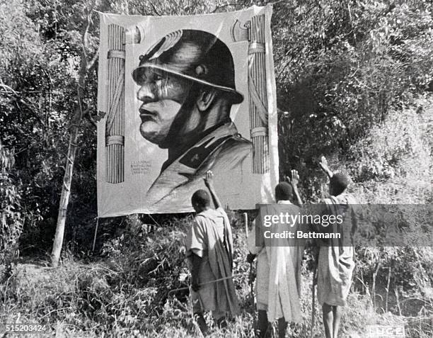 Ethiopia-Natives of a captured Tigre province pay their respects, Italian fashion, to a huge likeness of the "Great White Father."