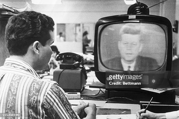 Miami, FL- Federico Fidel Fernandez, a Miami Cuban refugee, listens to President Kennedy's television address October 22nd, in which the President...
