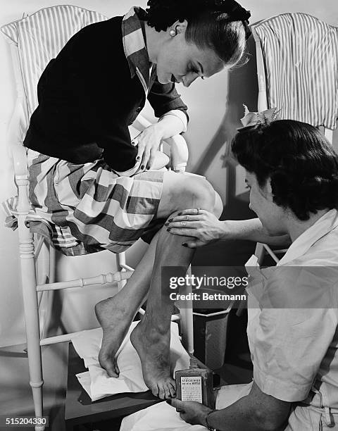 New York, NY- Dana Jenney watches closely while a trained attendant applies liquid stockings to her legs at the new leg bar opened at Lord and...