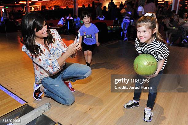 Actress Tiffani Thiessen and daughter Harper attend the Grand Opening of Bowlero on March 12, 2016 in Woodland Hills, California.