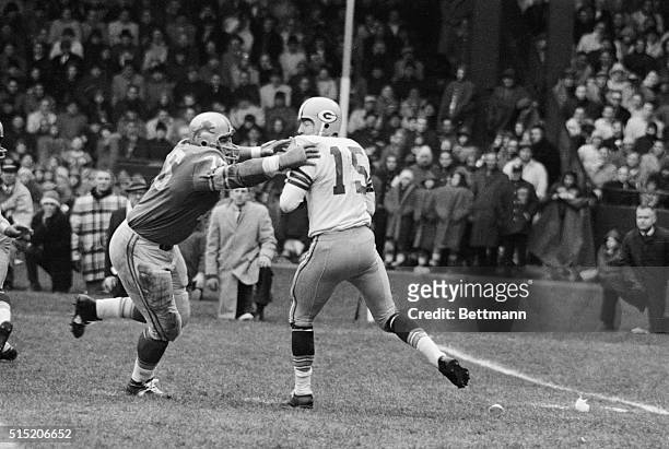 Detroit, MI- Detroit Lions' Roger Brown goes after Green Bay Packer quarterback Bart Starr , who was attempting a pass during the second quarter of...