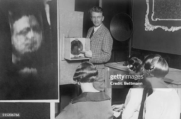 John Logie Baird demonstrates his "televisor", a receiver for a mechanical system of television transmission involving a spinning disk. The system...