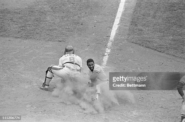 New York, NY- Battling for first place in the National League East, Cardinals' Ozzie Smith scores in a cloud of dust in the fourth inning 9/12 as...