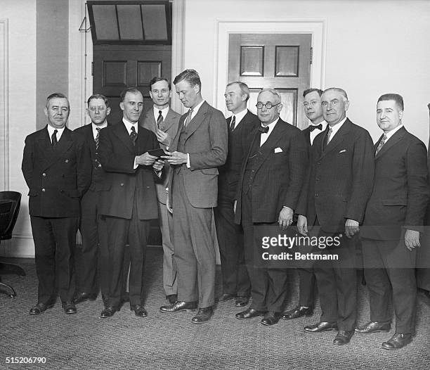 Colonel Charles A. Lindbergh in Washington, D.C., received an engraved membership card which made him an honorary member of the National Federation...