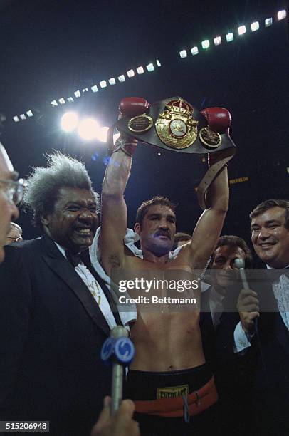 Cleveland, Ohio: Gerrie Coetzee holds up championship belt September 23 after scoring as upset knockout over WBA Heavyweight Champion Michael Dokes...