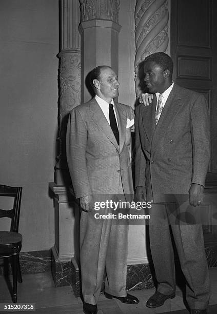 Leo Durocher, left, the fiery manager who will pilot the Brooklyn Dodgers in 1948, chats with Jackie Robinson, Brooklyn's "Rookie of the Year,"...