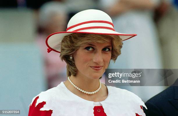 Diana, Princess of Wales, wears an outfit in the colors of Canada during a state visit to Edmonton, Alberta, with her husband.