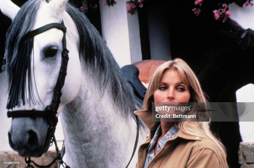 Actress Bo Derek Posing with White Horse