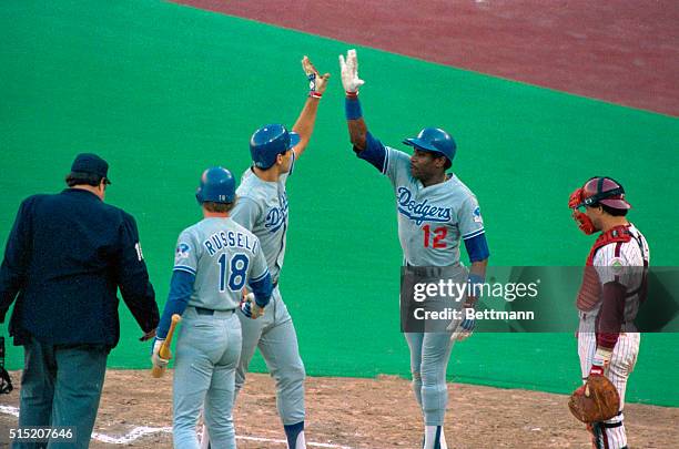 Teammates congratulate Dodgers' Dusty Baker at home plate during National League Championship Playoffs vs. The Philadelphia Phillies.