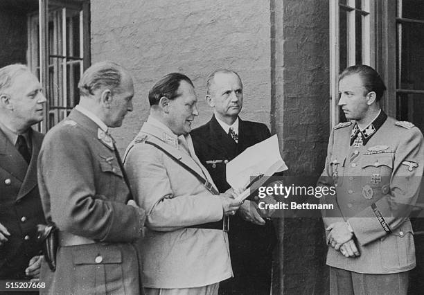 At Wolfsschanze headquarters, Hermann Fegelein , chief SS adjutant and brother-in-law of Eva Braun, shows his assignment to Joachim von Ribbentrop,...
