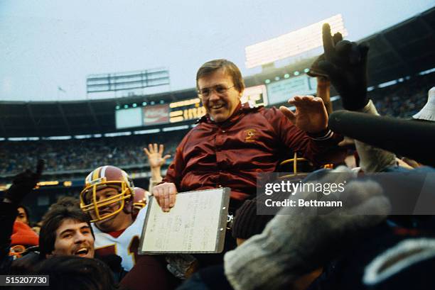 Coach Gibbs of Washington Redskins is carried off the field after defeating the Dallas Cowboys for NFC Championships.