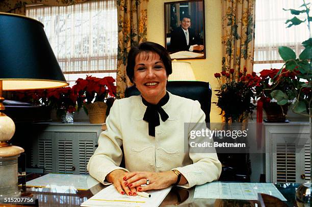 Close-up shows Elizabeth Dole, the Secretary of Transportation for the United States, sitting alone in her office.