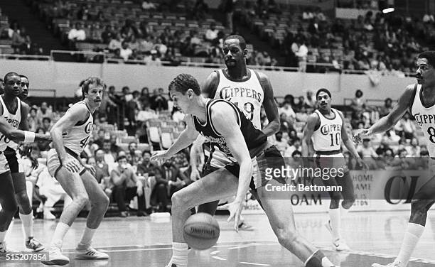 Sam Bowie of the Portland Trailblazers dribbles around Cedric Maxwell of the Los Angeles Clippers during a basketball game in Los Angeles, California.