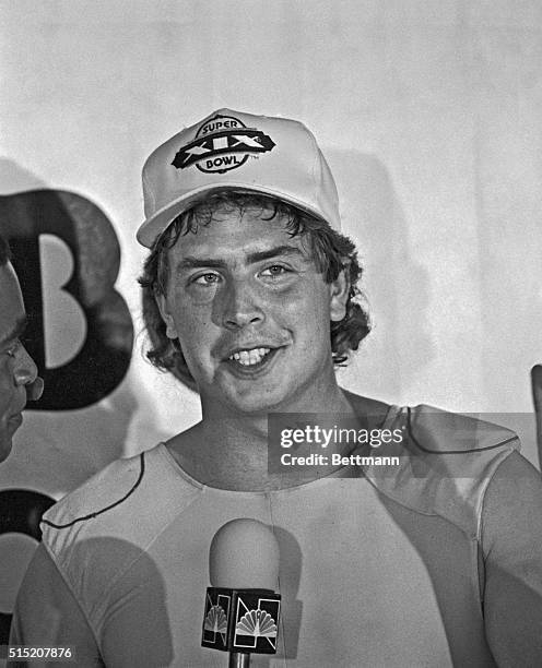 Miami quarterback Dan Marino, who had a record breaking performance in the AFC Championship game, sports a Super Bowl XIX hat in the locker room....