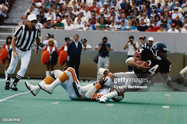 Jeff Fisher is shown being tackled by an opponent on the ground in a game between the Chicago Bears and the Tampa Bay Buccaneers.