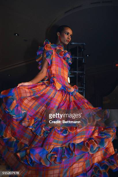 Fashion model Iman wears a bright plaid gown for Bill Blass' Spring collection show.