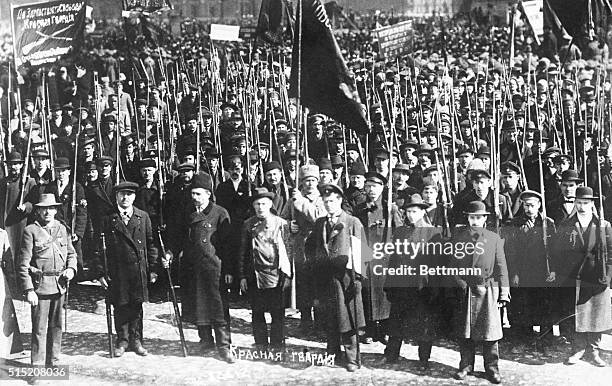 An armed group of Red Guards mass in the street near the Bolshevik headquarters in Petrograd during the Russian Civil War.