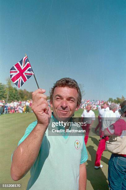 Dublin, Ohio: European team captain Tony Jacklin waves the British flag after the European team won the Ryder Cup here. The Europeans won 15-13.