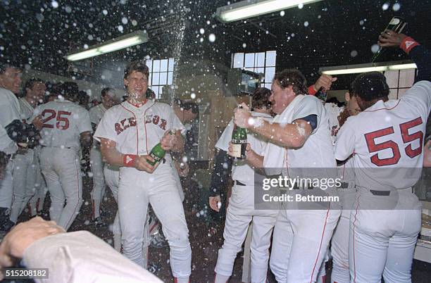 Boston: Red Sox players celebrate in the locker room with champagne after they defeated the Toronto Blue Jays 12-3 to win the American League East...