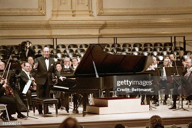 New York, NY: Pianist Vladimir Horowitz acknowledges applause after his surprise appearance at the re-opening of Carnegie Hall.