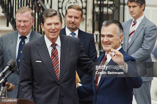 American President Ronald Reagan looks on as Mexican President Miguel de la Madrid waves during Reagan's state visit. The two leaders met earlier to...