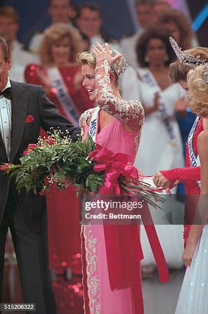 Christy Fichtner of Texas steadies her crown after being chosen 1986 Miss America.