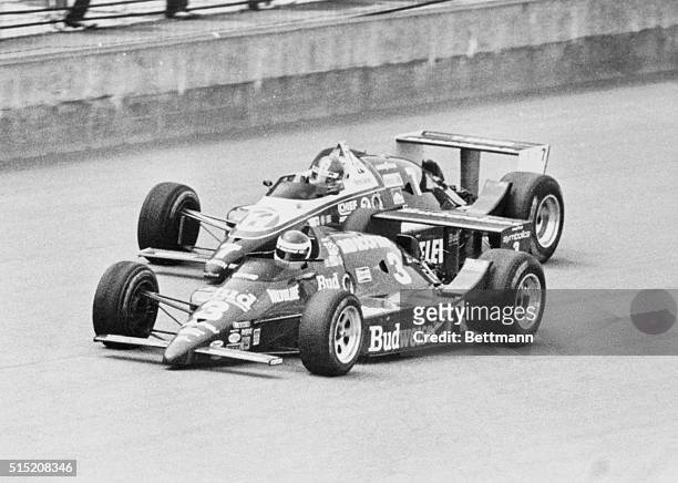 Indianapolis 500-Speedway, Ind.: Bobby Rahal passes Kevin Cogan on the main straight with two laps to go, on the way to victory in the 70th edition...
