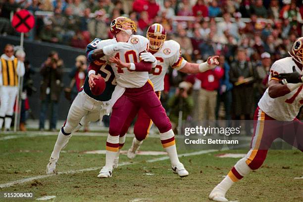 Washington Redskins quarterback Jay Schroeder is sacked by new York Giants linebacked Lawrence Taylor causing a fumble that the Redskins recovered...