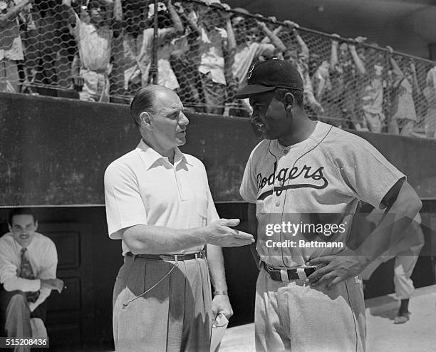 Leo Durocher, left, manager of Brooklyn Dodgers, shown with Jackie Robinson at their spring training camp.