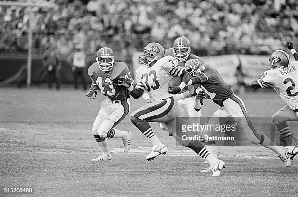 San Francisco's Roger Craig turns up the speed to elude a pack of Denver Bronco defenders during first quarter action between the Denver Broncos and...