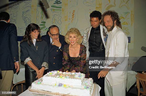 Hollywood: Flanked by her daughter Melissa, husband Edgar Rosenberg, announcer Clint Holmes and musical director Mark Hudson, Joan Rivers cuts a...