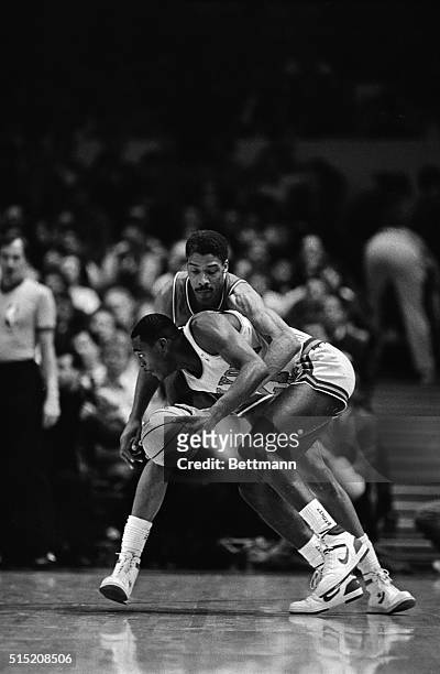 Philadelphia 76ers' Julius Erving reaches around the New York Knicks' Gerald Wilkins to try to make a steal in the first period here 1/27. Erving...