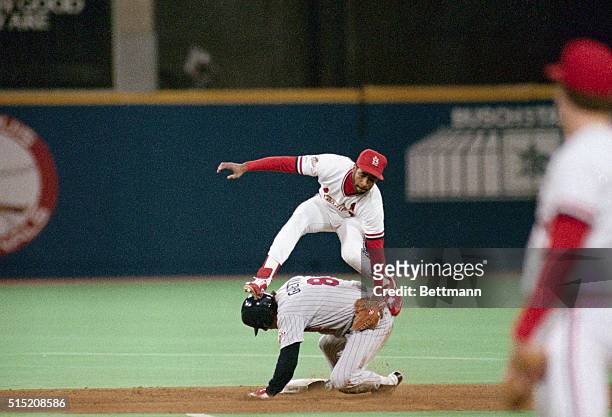 St. Louis: Cardinal Ozzie Smith leaps over a sliding Twins' Gary Gaetti, who is safe with a second inning steal, October 21st.