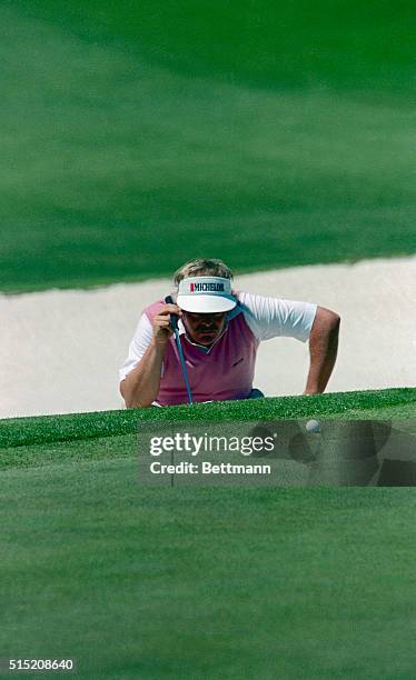 Augusta: Third round coleader Roger Maltbie gets a close look as he line up his par putt on the 2nd hole during the final round of the Masters 4/12....