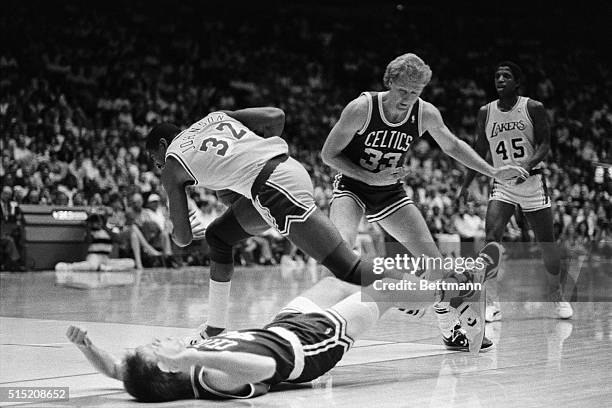 Lakers' James Worthy is taken to the floor by Celtics' Greg Kite as Lakers Earvin Johnson looks on during 2nd quarter action of Game 4, at the Boston...