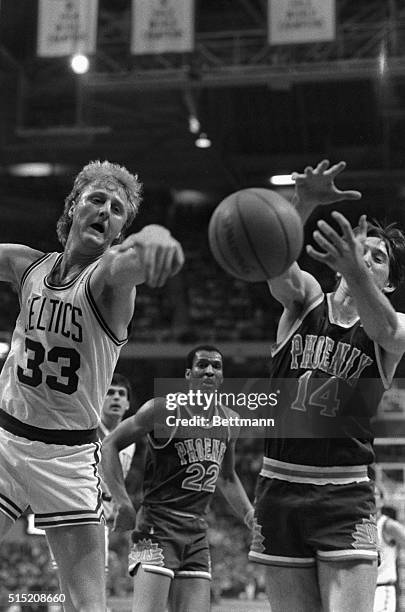 Celtics' Larry Bird and Phoenix Suns' Jeff Hornacek go after a rebound during 2nd quarter action of the game at Boston Garden, 3/11. Looking on is...