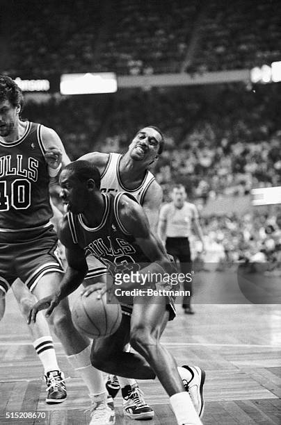 Bulls' Michael Jordan drives past Celtics' Dennis Johnson to basket in the third quarter of the second game of the NBA Eastern Division Quarterfinal...